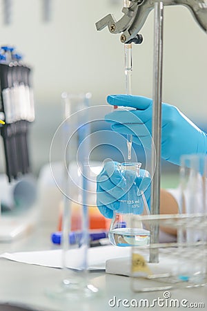 The woman whoâ€™s the scientist is demonstrate the titration technique Stock Photo